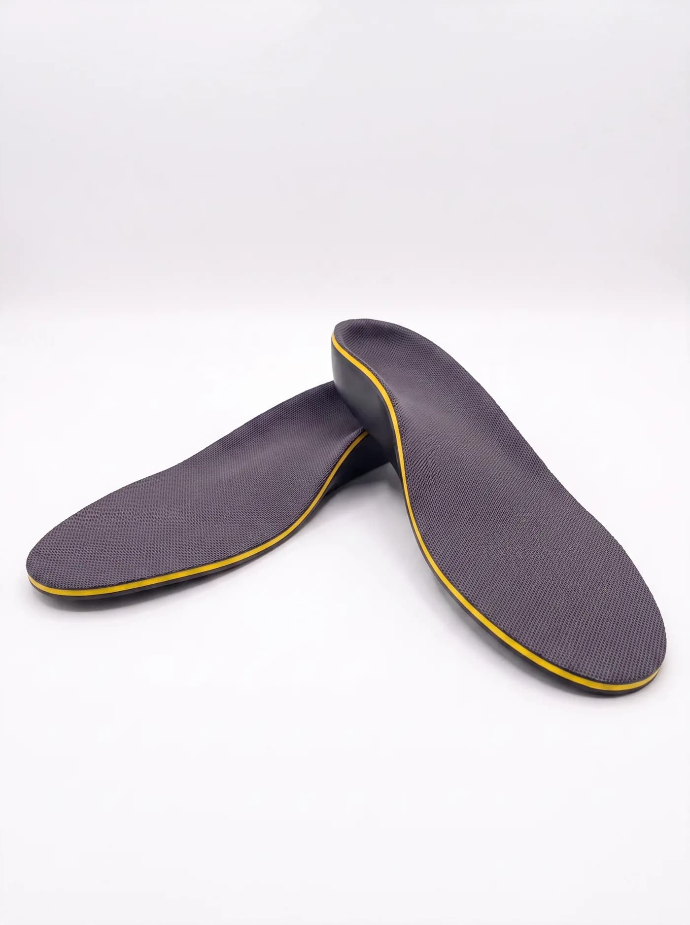 A pair of Akrolimb Sport insoles — grey mesh tops with a yellow trim edge